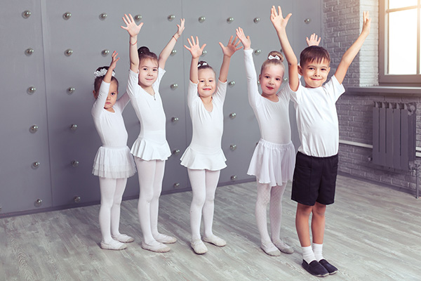 group-four-little-ballerinas-kid-ballerun-posing-together-practicing