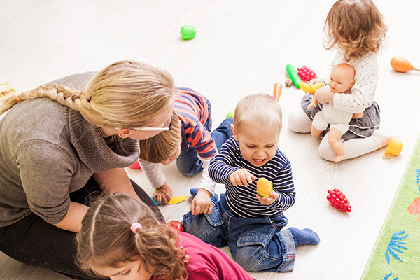 rear-view-people-sitting-with-toy